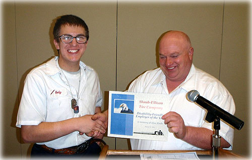 jpg Kody Rhodes presents the Alice Rocke Disability-Friendly Employer of the Year Award to Ernie Corona of Shaub-Ellison Tire Company