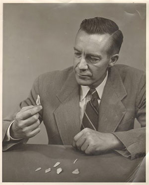 jpg Alaska archaeologist and adventurer J. Louis Giddings inspects an artifact.