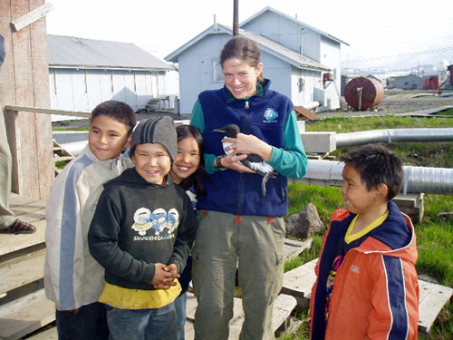 jpg Biologist Julie Hagelin holds a murre while surrounded by children in the village of Savoonga on St. Lawrence Island.