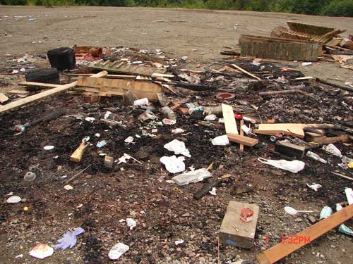 jpg Material dumped off Revilla Rd. for someone to clean up.  Burned pallets have hundreds of nails in them.