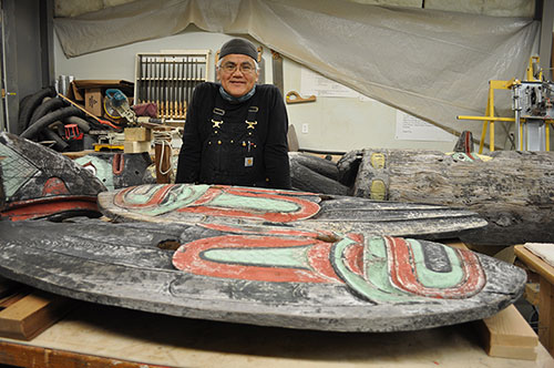 jpg Tlingit Master Carver Wayne Price of Haines stands near the totem he is restoring. 