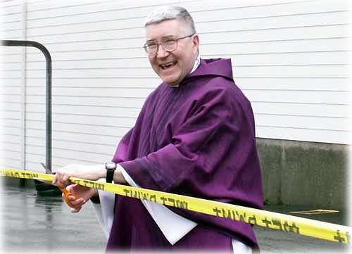 jpg Father Travers cuts the ribbon.