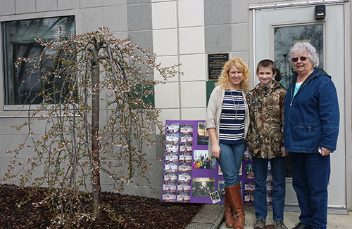 jpg Mille Campbell (Right) with her grandson Hunter Mathews and Heather Dalin. To the left is pictured "The Giving Tree".