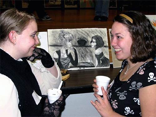 jpg Brittany DeCourcey and Victoria Clary pose in front of  DeCourcey's art work