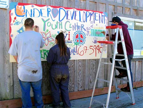 jpg Volunteers put the final touches on a sign announcing the development project.