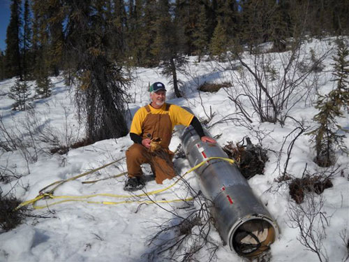 jpg Chris Christenson of NASA helps attach a rocket payload to a helicopter sling near a small arctic creek 170 miles north of Chatanika, Alaska