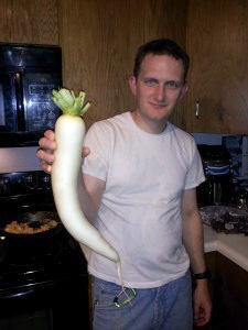 jpg Nathan O’Dell-Andersen holds a radish grown at Frozen Fireweed Farm.