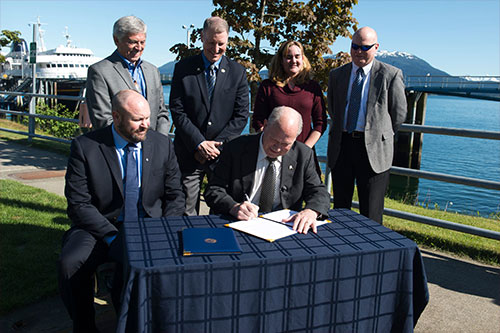 jpg Governor Walker Signs Memorandum of Understanding with Southeast Conference to Improve Ferry System as other officials look on...