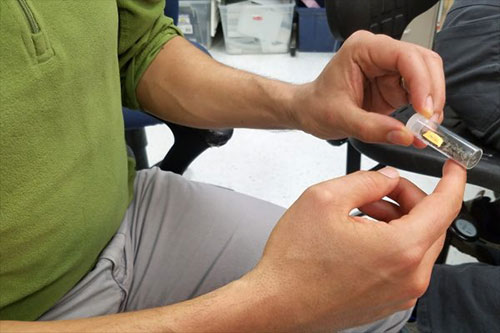 jpg Andrés López looks at a vial full of 70 million-year-old fish fossils.