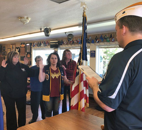 jpg Veterans of Foreign Wars Post 4352 Commander Paul Robbins Jr. (Right) administers the oath of office to Auxiliary President Joey Tillson (Holding the flag) and other incoming officers to the Auxiliary during a ceremony on April 27, 2019