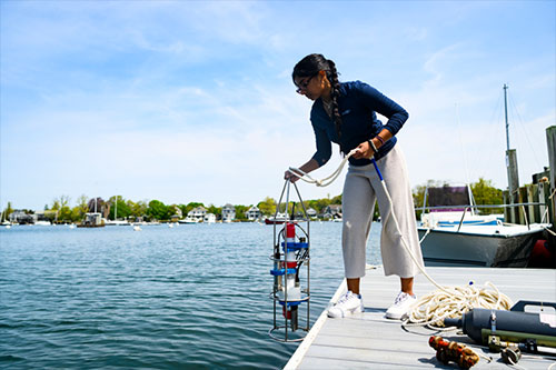 jpg Co-op student Anushka Rajagopalan at the dock by the Woods Hole Oceanographic Institution on Cape Cod, where she is studying Alaskan algal blooms that cause paralytic shellfish poisoning.