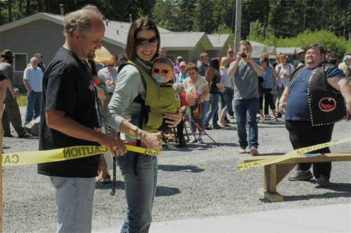 jpg on Wunrow, Project Manager for the Organized Village of Kasaan and Tessa Axelson, Sr. Program Manager, the Denali Commission cutting the ribbon with Richard Peterson (far right), President of the Organized Village of Kasaan looking on.