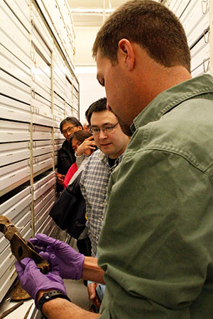 jpg Jason Rogers of Northern Land Use Research Alaska, in foreground, and Kaktovik resident Matthew Rexford discuss artifacts from the Barter Island collections.