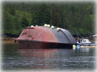 Spill containment boom set around grounded fishing vessel 