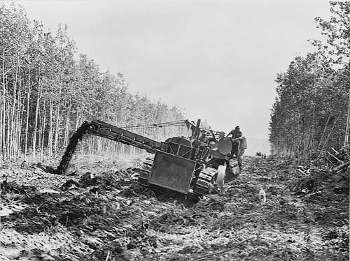 jpg Dumping mud into the side of the highway and widening the road, along the Alcan Highway.