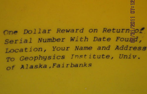 jpg A close-up of the discs message, indicating theres $1 reward if the disc is found and returned to the Geophysical Institute.