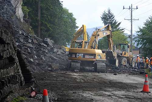 jpg Secon clears rocks after blast...