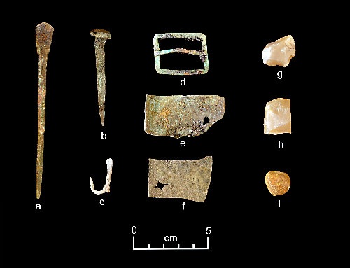 jpg A representative collection of artifacts discovered in July 2015 includes (from left) part of a set of dividers, a nail, a fishhook, a buckle, sheet copper, gun flints and a musket ball.