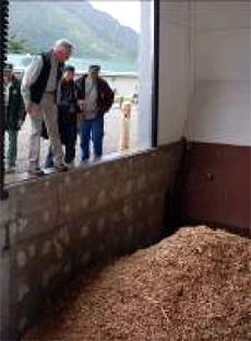 jpg Ed Schafer inspects the wood chip bins of the City of Craig