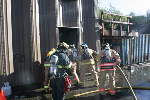 Firefighter Instructor Jay Diorec of the Ketchikan Fire Department (Foreground, In Black) Instructs Firefighter-I candidates as they enter the training tower 