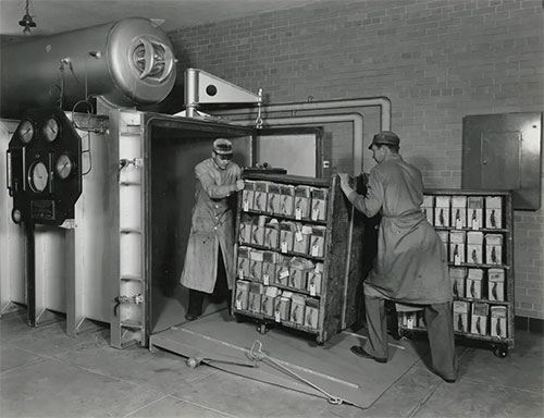 jpg Before the establishment of the archives, many records were poorly stored. Here archives workers push a cart of Veterans Administration records into a vacuum chamber for fumigation in June 1936