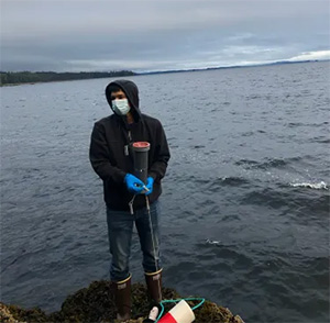jpg Simon Friday prepares to pour a sample of seawater at a Kake Climate Partnership ocean monitoring site in 2020