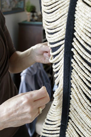 jpg Sitka artist Cynthia Gibson works on her salmon bone dress, which contains approximately 20,000 vertebrae.