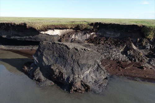 jpg A hunk of soil drops into the sea at Drew Point in summer 2018.