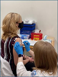 jpg Pictured to the right is pharmacist Kalli Kline administering a COVID-19 vaccine to pharmacist Torrie Wolery.  