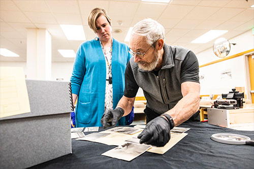 jpg Rasmuson Library archivist Rachel Cohen and professor Matthew Sturm look at Sourdough Expedition photographs that Sturm unexpectedly found during unrelated research.