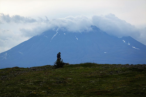 jpg A hiker pauses beneath the volcano Mt. Peulik on the Alaska Peninsula