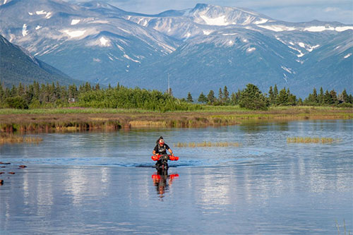 jpg Bjørn Olson riding through a slough near Lake Iliamna.