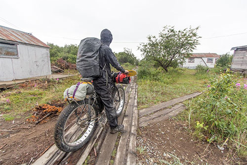 jpg Riding through a village during Bjørn Olson's trip from Cook Inlet to Bristol Bay