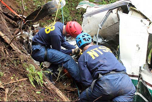 jpg NTSB investigators Brice Banning and Clint Crookshanks on scene examining the wreckage of a sightseeing plane that crashed in Alaska on June 25, 2015.