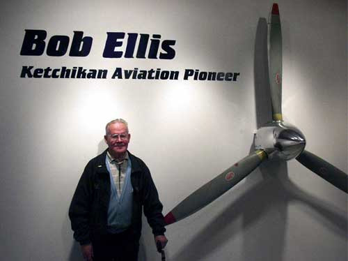 jpg Former Ellis Airline's chief pilot, Bud Bodding poses next to a three-blade Goose propeller that greets visitors to the Bob Ellis exhibit at the Tongass Historical Museum. Date: December 2004