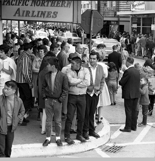 jpg People on the street in Ketchikan in front of Pacific Northern Airlines building, July 5, 1967 