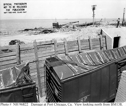 jpg Railroad cars full of munitions in a revetment at Port Chicago, California, United States damaged by a massive explosion the night before.