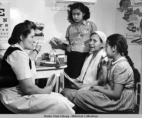 jpg A nurse on the vessel Hygiene explains to a woman and two young girls about Tuberculosis.