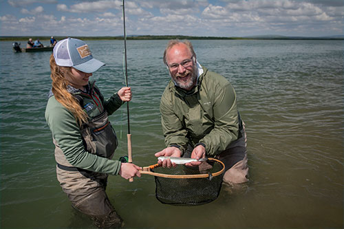 jpg Abbey Whitcomb and her client, Naknek resident Bryon Singly, pose with a small rainbow on the Naknek River. 