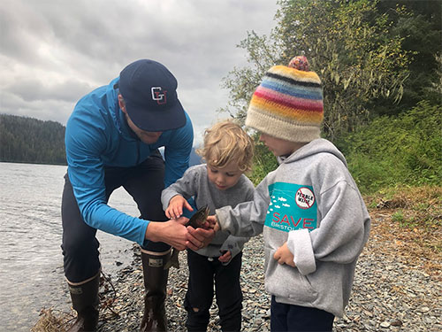 jpg Sam and Silas Muse and Shiras Dihle inspect a cutthroat trout caught at Hasselborg Lake before returning it to the water. 