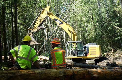 jpg Hydrologist and project lead Heath Whitacre and VetsWork by Americorps’ Taran Snyder watch Rock-N-Road Construction’s Jode Coil at work. 